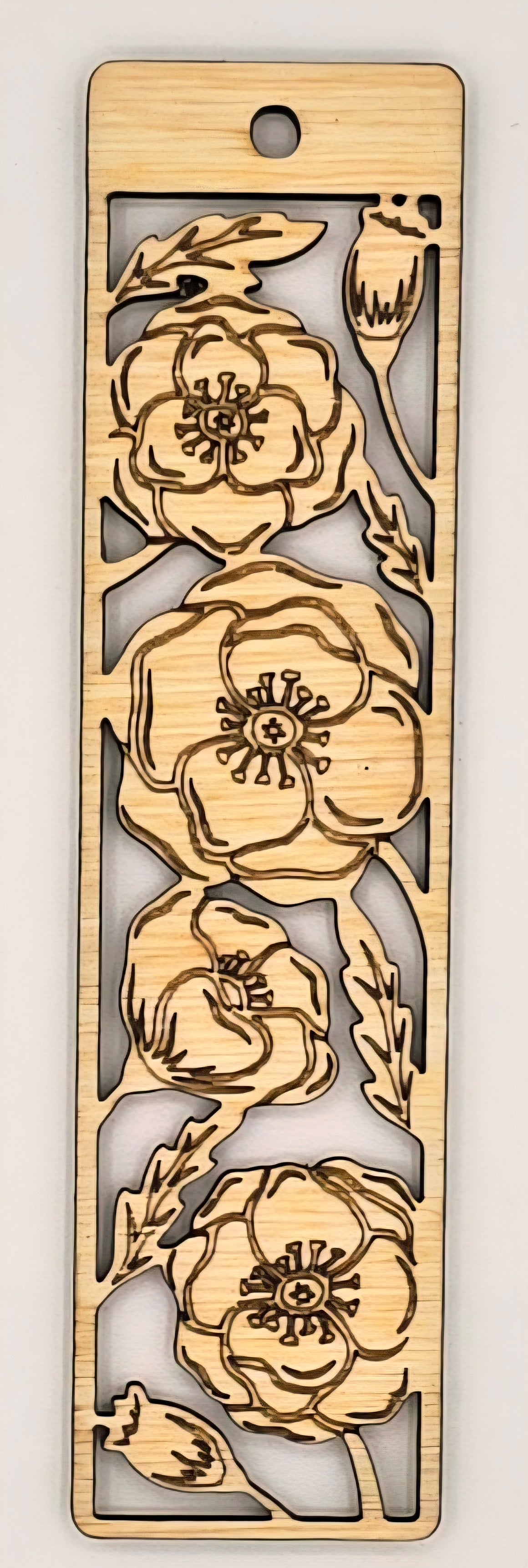 Wooden bookmark with floral cutout design on a plain background