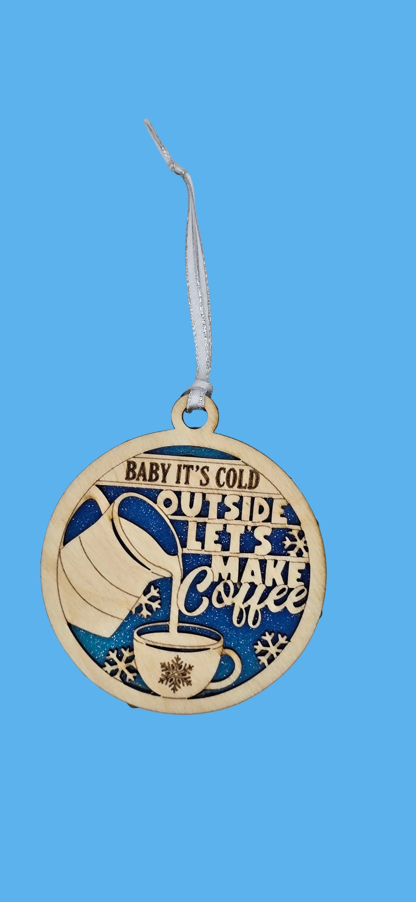 Decorative ornament with text and a cup design on a light gray background