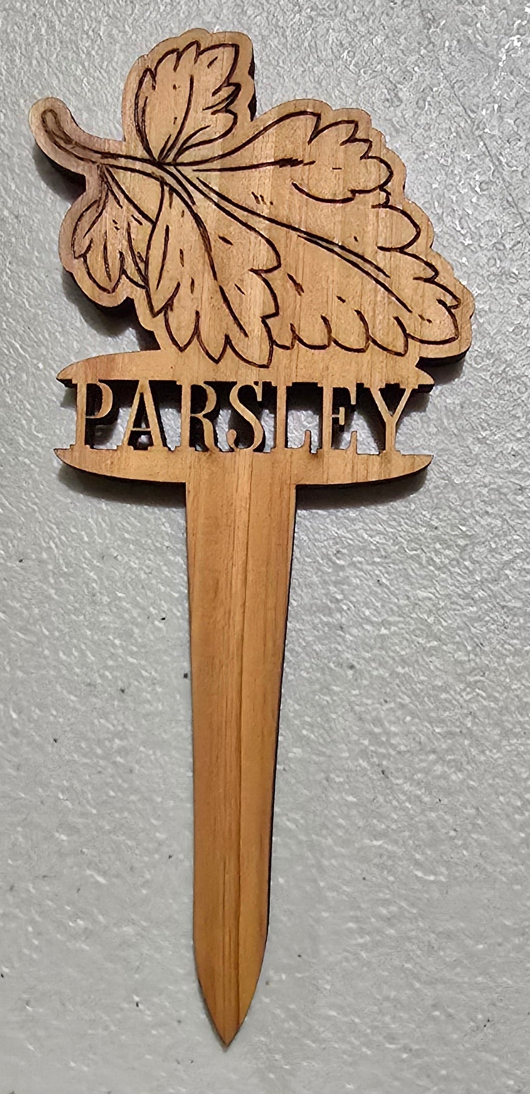 Wooden parsley plant marker design on a light gray background