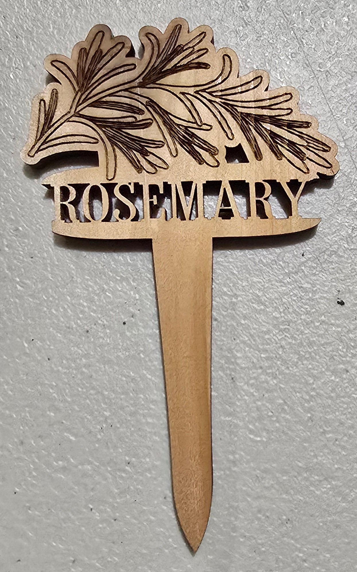 Wooden Rosemary plant marker design and 'Moscow' text on a light gray background