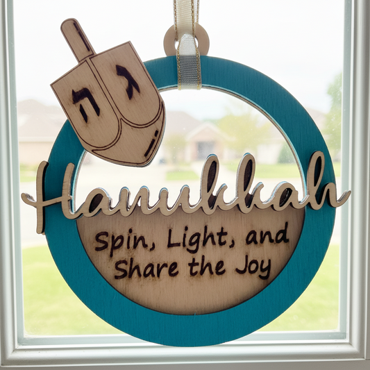 Decorative Hanukkah ornament with dreidel and text 'Hanukkah Spin, Light, and Share the Joy' on a blue circular background.