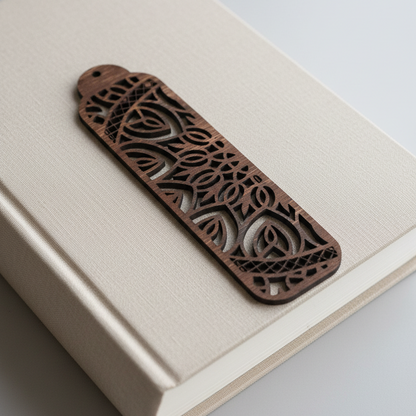 Decorative wooden bookmark on an open book with a plain background