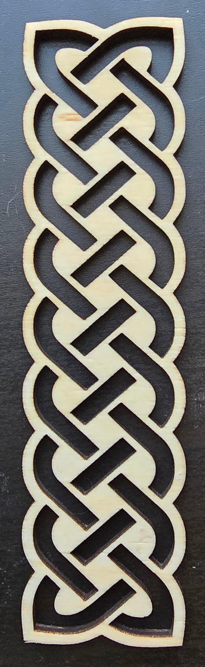 A laser engraved wooden bookmark with a Celtic knot design.