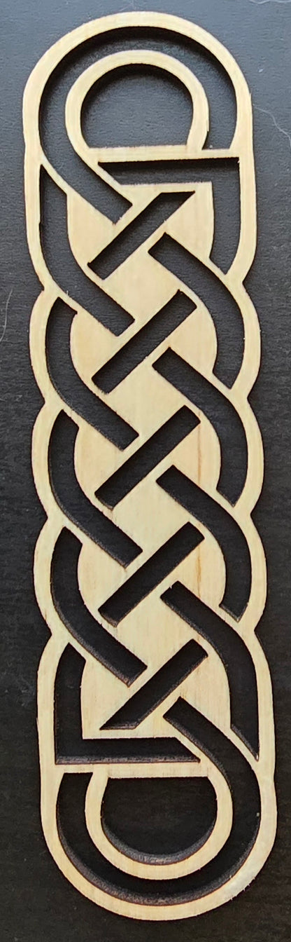 A laser engraved wooden bookmark with a Celtic knot design.