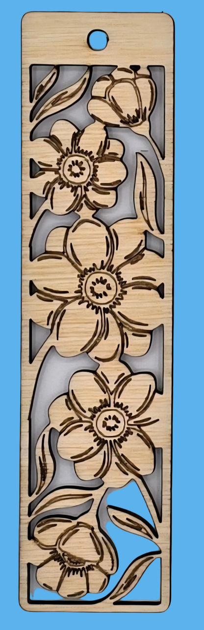 Wooden bookmark with floral cutout design on a gray background