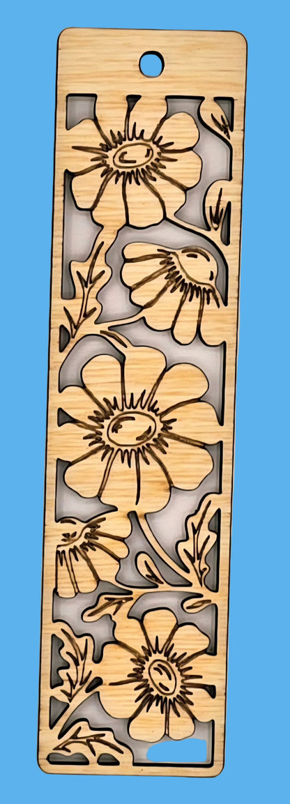 Wooden bookmark with floral cutout design on a beige background