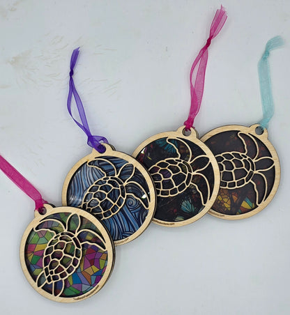Decorative turtle ornaments with stained glass design on a white background