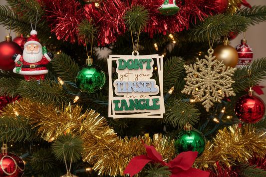 Decorative sign with text 'Don't get your tinsel in a tangle' on a blue background
