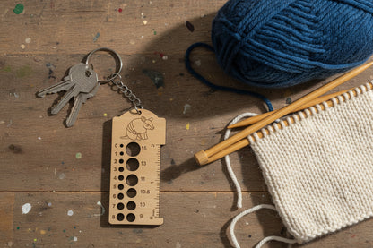Wooden keychain with ruler and armadillo design on a white background