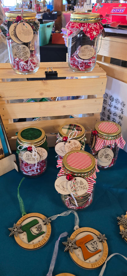 Decorative items including jars and wooden plaques on a table with a blue surface.