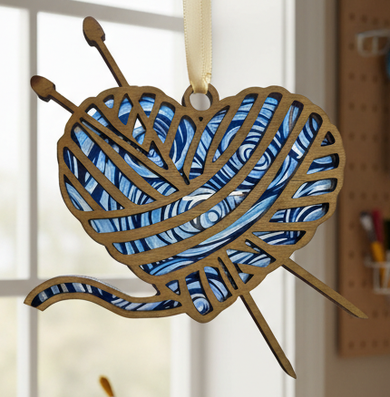Decorative heart-shaped knitting needle holder hanging in a craft room with sewing equipment.