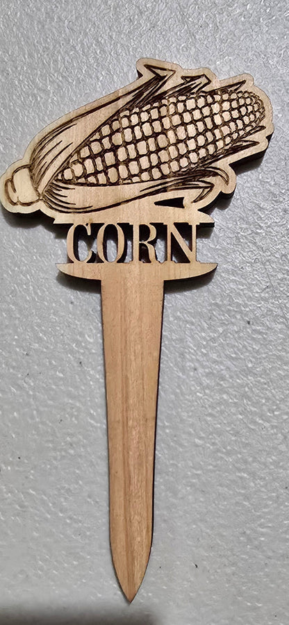 Wooden corn on the cob-shaped toothpick on a gray surface