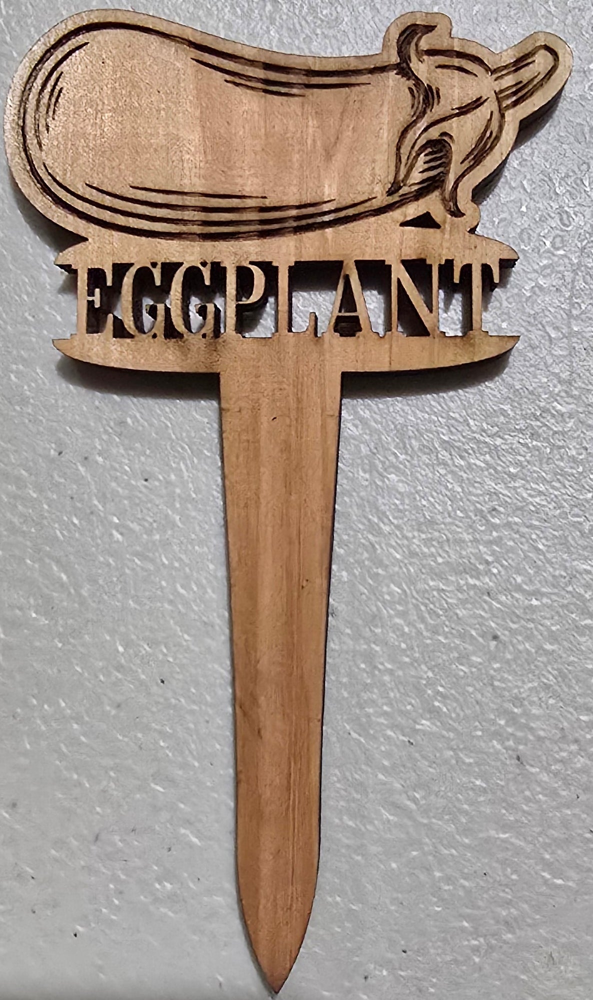 Wooden tool with a handle and blade on a gray background