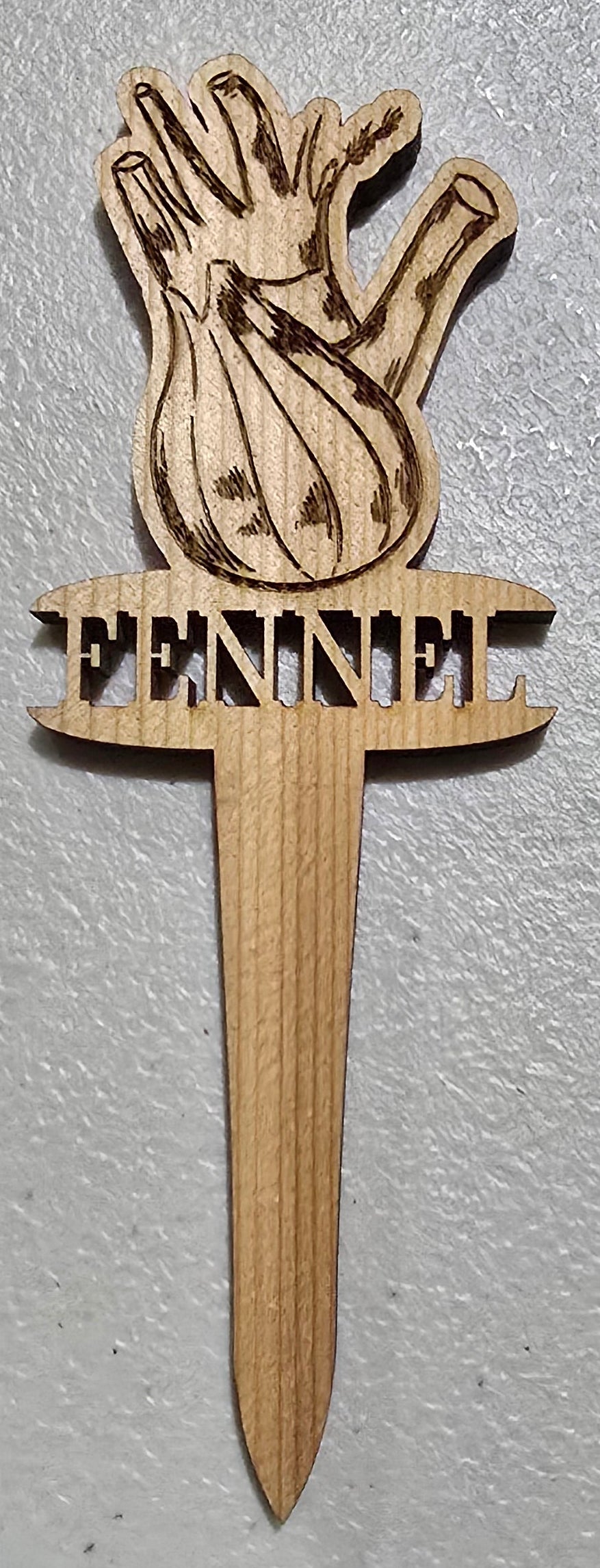 Wooden hand-shaped pick with 'Prairie' branding on a white surface