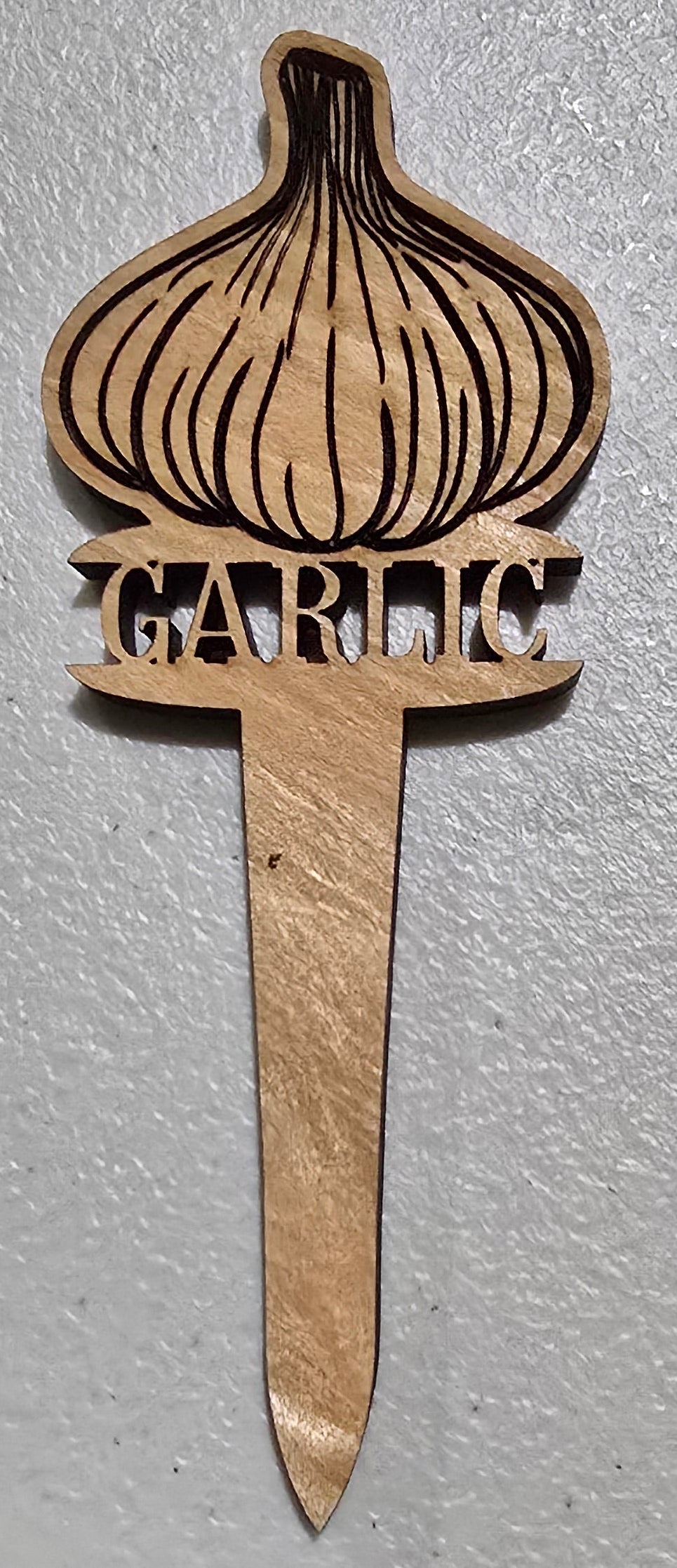Wooden comb with decorative design on a light gray background