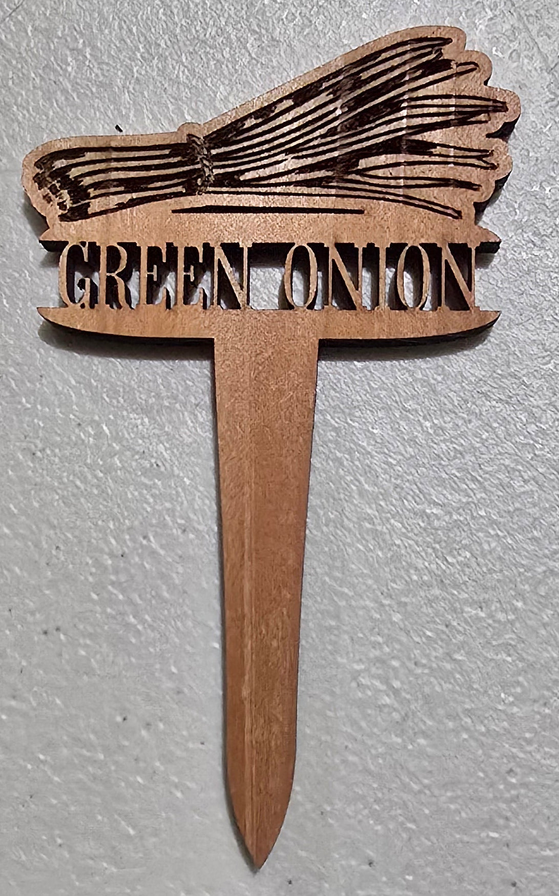 Cardboard broom with 'Broom Canyon' branding on a light gray background