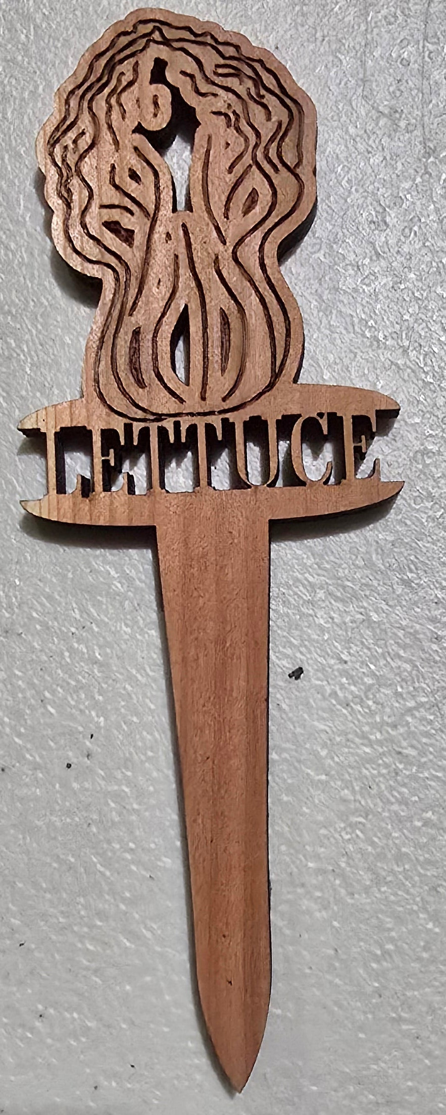 Wooden sword model on a light gray surface