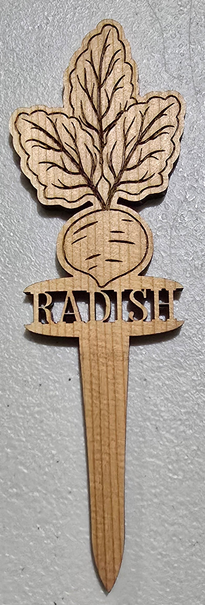 Wooden radish plant marker on a white background