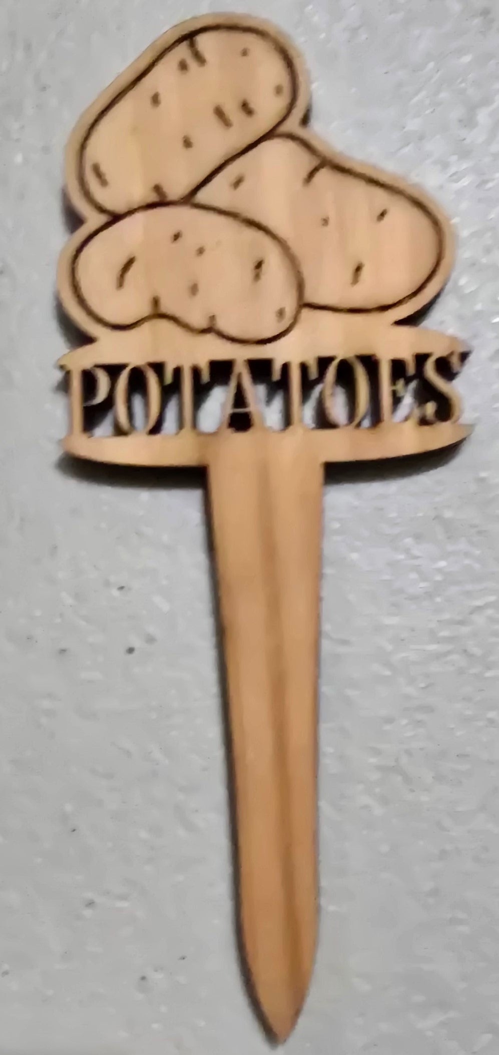 Wooden skewer with a potato design and 'ROMANIA' text on a white background