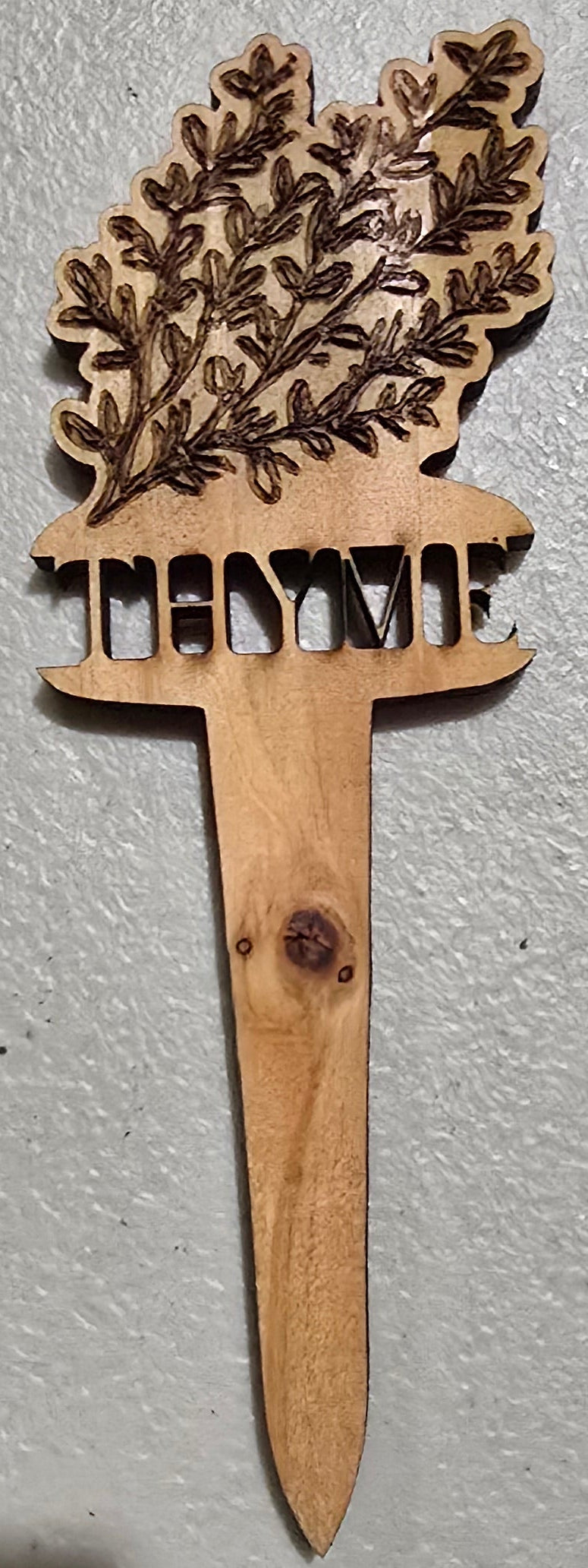 Wooden Thyme plant marker design on a light gray background