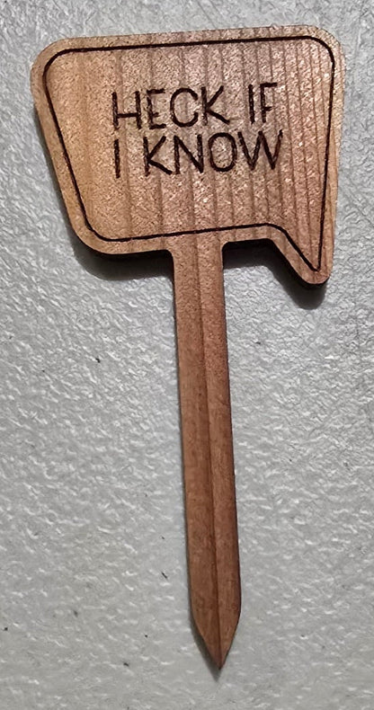 Wooden paddle with 'HECK IF I KNOW' text on a gray background