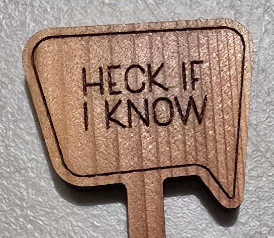 Laser engraved wooden plant stake sign reading "Heck If I Know" speech bubble shape

