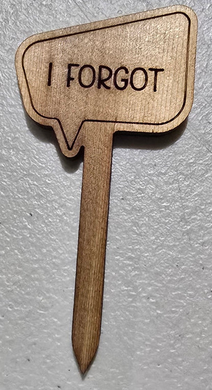 Wooden sign shaped like a speech bubble with 'I FORGOT' text on a light gray background