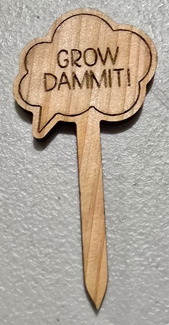 Wooden plant label with 'Grow Damn It!' text on a light gray background