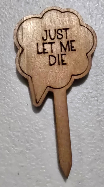 Wooden sign shaped like a cloud with 'JUST LET ME DIE' text on a white background
