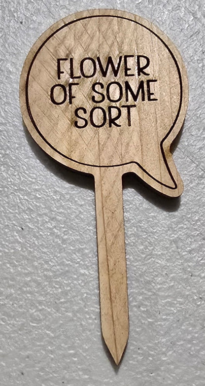 Wooden pick with 'Flower of some sort' text on a light gray background