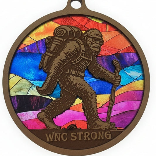 Colorful medallion with a design of a person climbing a mountain held by hands on a light background