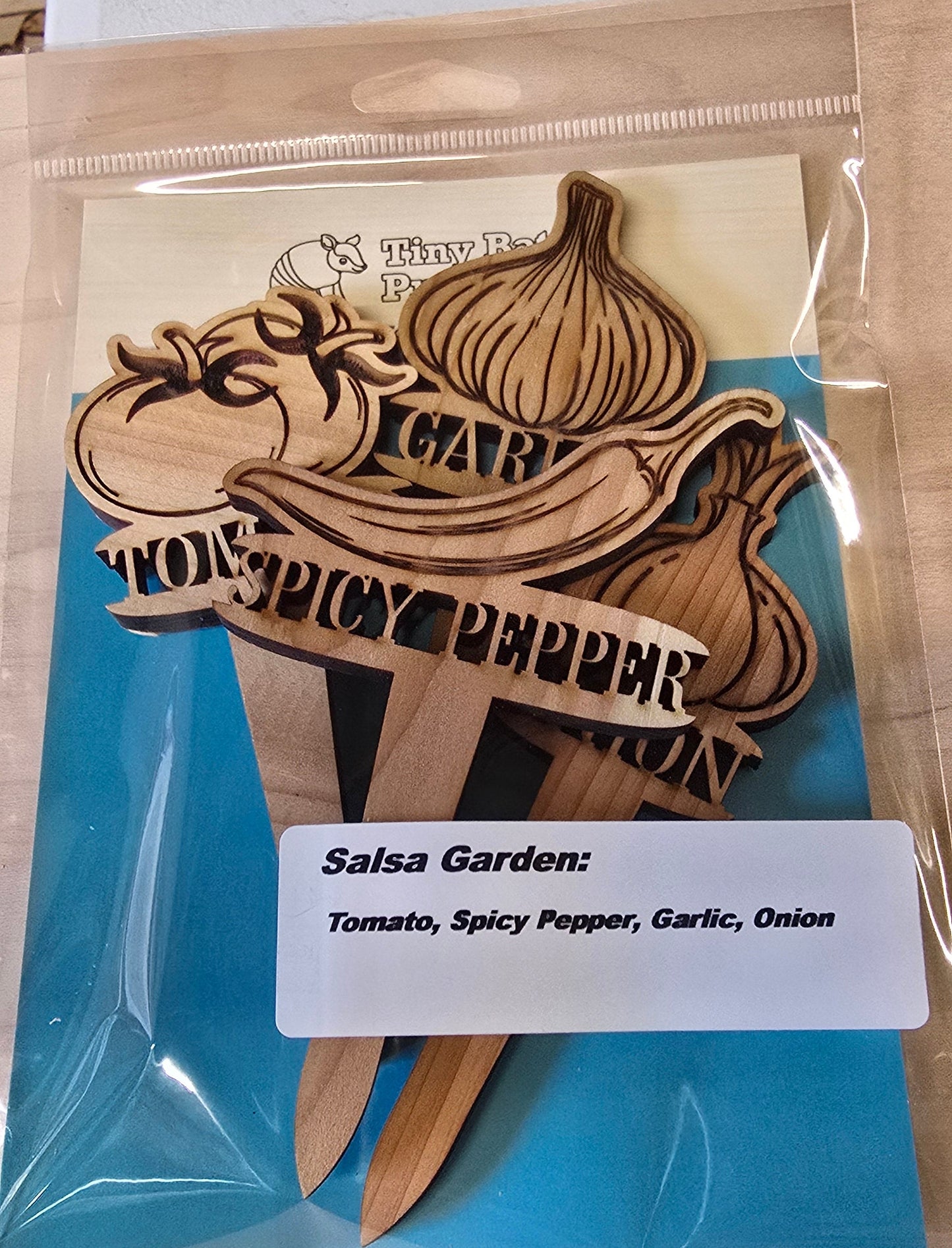 Wooden product with branding on a blue card and clear packaging.