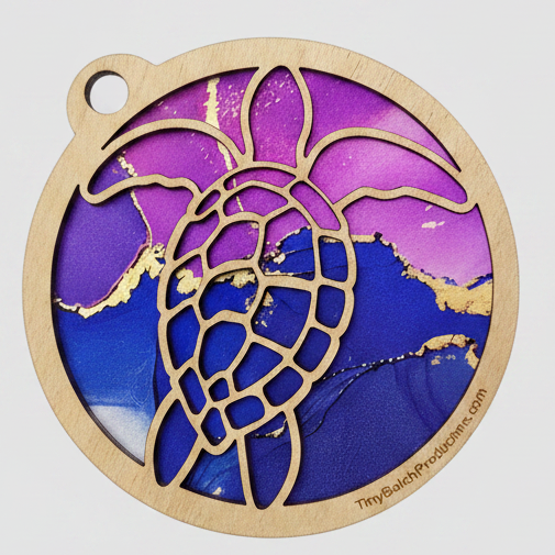 Decorative pendant with purple and blue design on a light gray background