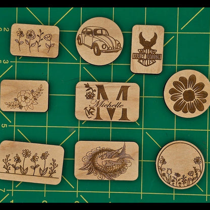Set of wooden stamps on a green cutting mat with measurement lines.