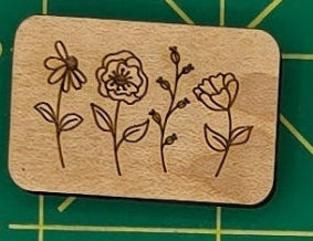 Collection of wooden stamps with various designs on a green cutting mat.